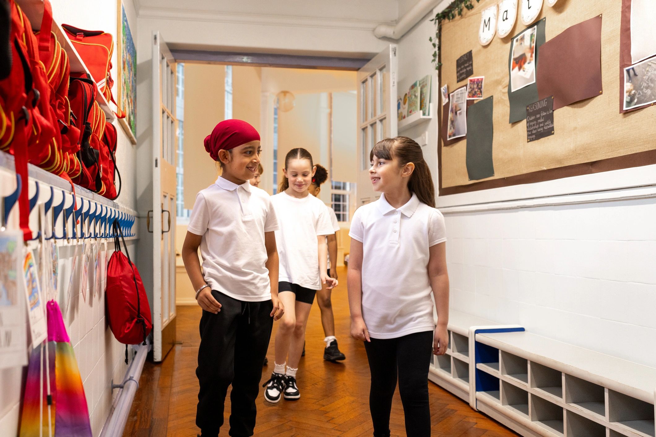 Students walking through a bright school hallway